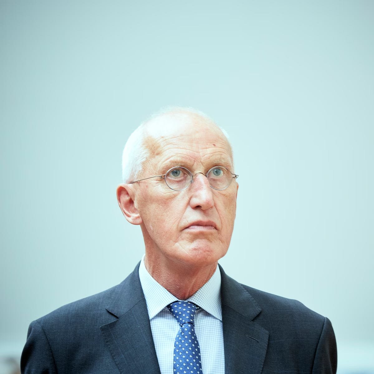 A portrait photograph of Rein Jan Hoekstra, a high-ranking Dutch official with short grey hair and glasses, wearing a dark suit and blue tie. He is looking slightly away from the camera with a serious expression. The image is positioned within an article draft detailing his role in the 1992 destruction of sensitive Dutch military intelligence archives. A portrait photograph of Rein Jan Hoekstra, a high-ranking Dutch official with short grey hair and glasses, wearing a dark suit and blue tie. He is looking slightly away from the camera with a serious expression. The image is positioned within an article draft detailing his role in the 1992 destruction of sensitive Dutch military intelligence archives.